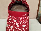 a close up of a baby ' s red and white polka dot pram