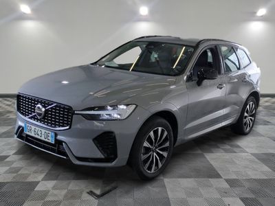 un SUV Volvo gris garé dans un garage au sol en damier