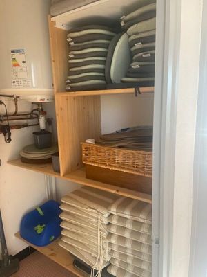 many plates and pans stacked on a shelf in the kitchen