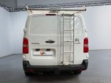 a white van with a ladder on the back of it