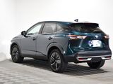 the rear end of a blue 2020 toyota rav parked on a checkered floor