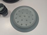 a table with plates and cups on it and a person standing next to it
