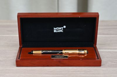 a wooden box with a pen in it sitting on a table