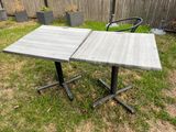 two tables that are sitting in the grass