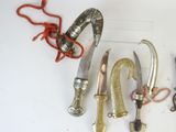 several different types of knives are displayed on a white surface