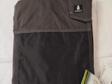 a bag that is sitting on a bed with a passport in it