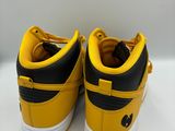 a pair of yellow and black sneakers on a white surface