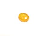 an image of a piece of yellow glass sitting on top of a white surface