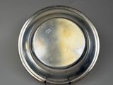 a silver plate with a hole in the middle of it