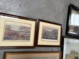 many framed pictures hanging on the wall of a room