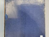 a blue book sitting on top of a white table