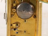 a gold clock with a glass case on it