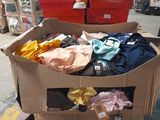 a cart full of clothes and other items in a warehouse