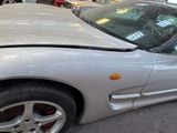 a silver sports car that is parked in a garage