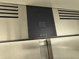 a stainless steel refrigerator with a black panel on the door