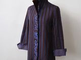 purple and blue striped shirt on a mannequin stand