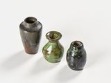 three vases sitting next to each other on a white surface