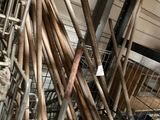 many baseball bats in a metal basket on the floor