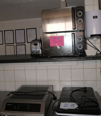a microwave and a toaster sitting on a counter in a kitchen