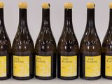 six bottles of wine are lined up on a table