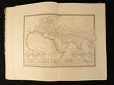 an old map of the world in a book on a black background