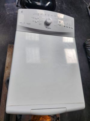 a white dishwasher sitting on top of a stove in a kitchen