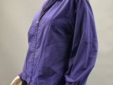 an image of a mannequin wearing a purple jacket and black pants