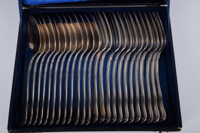 a lot of forks in a blue box on a table