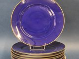 six blue and gold plates stacked on top of each other