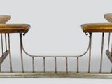 two wooden benches with metal bars on top of them