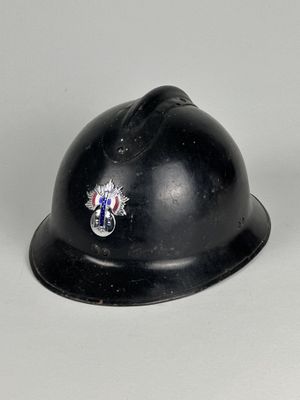 un casque noir orné d'un insigne sur un fond blanc