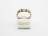 a close up of a ring on a stand on a white surface