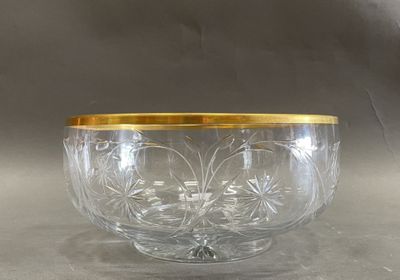 an image of a glass bowl with gold rim sitting on a table