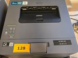 a printer sitting on top of a desk next to a printer