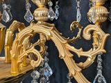 a gold chandelier with crystal beads hanging from it