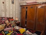a bed that has a lot of clothes on top of it