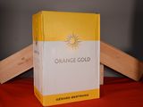 a box of orange gold sitting on a red cloth