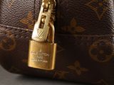 a close up of a louis vuitton bag with a lock on it