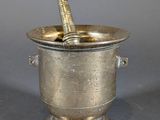 silver plated wine bucket with a cork in it on a gray surface