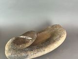 a rock with a stone on top of it on a table
