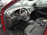 the interior of a red car with a steering wheel and dashboard