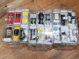 many different types of toy cars in a plastic box