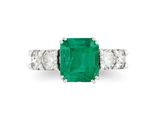 an emerald and diamond three stone ring