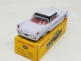 a white toy car sitting on top of a yellow box