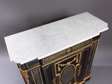 a black and gold painted cabinet with a marble top