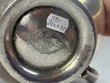 someone is holding a silver cup with a sticker on it