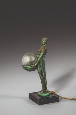an image of a statue of a man holding a ball on a rope