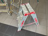 a metal step stool sitting on the floor in a store