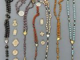 a collection of various rosary and other religious items