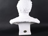 white marble bust of a man with a short hair on a black background